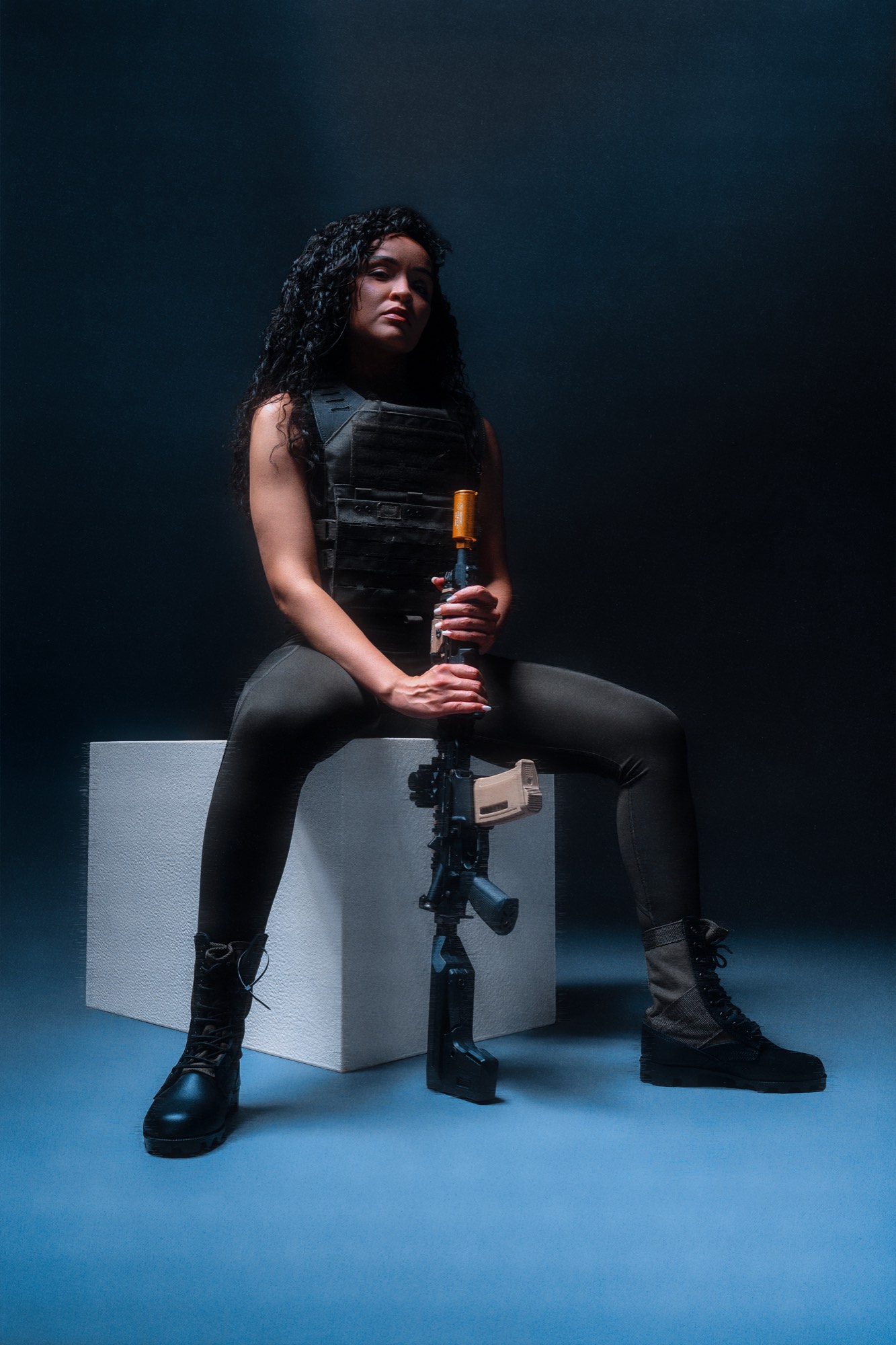 Walnette seated with rifle, neon split lighting